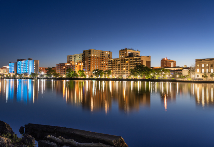 Wilmington, North Carolina, USA downtown city skyline on the Cape Fear River at night.
